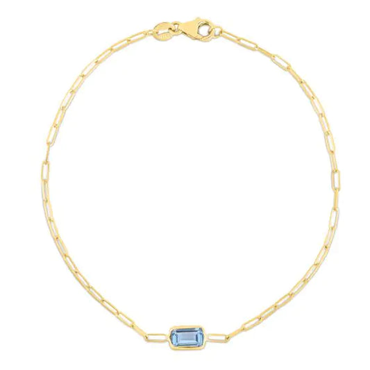 Gold paperclip bracelet with blue topaz gemstone